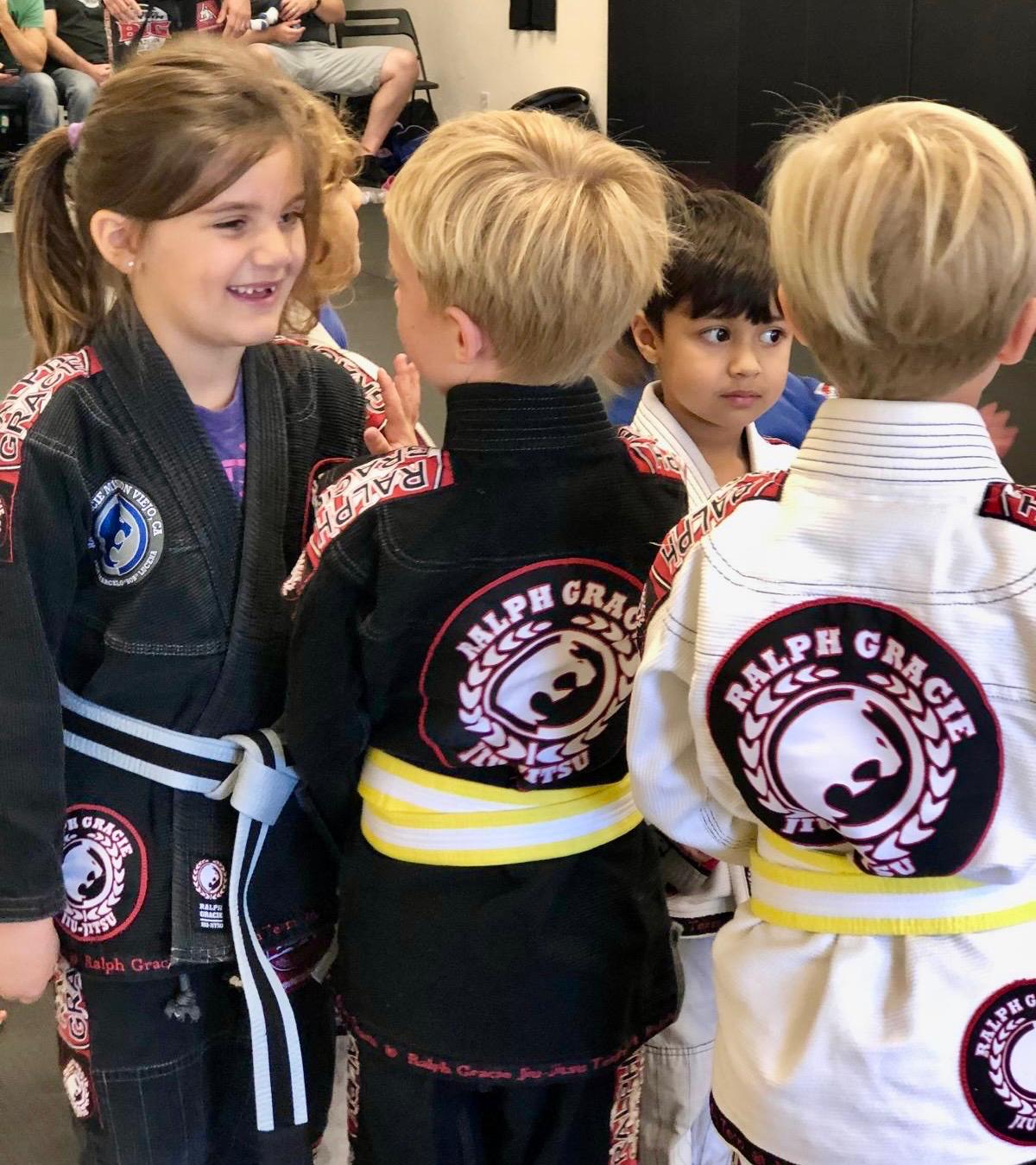 Mission Jiu Jitsu kids showing Ralph Gracie team patches