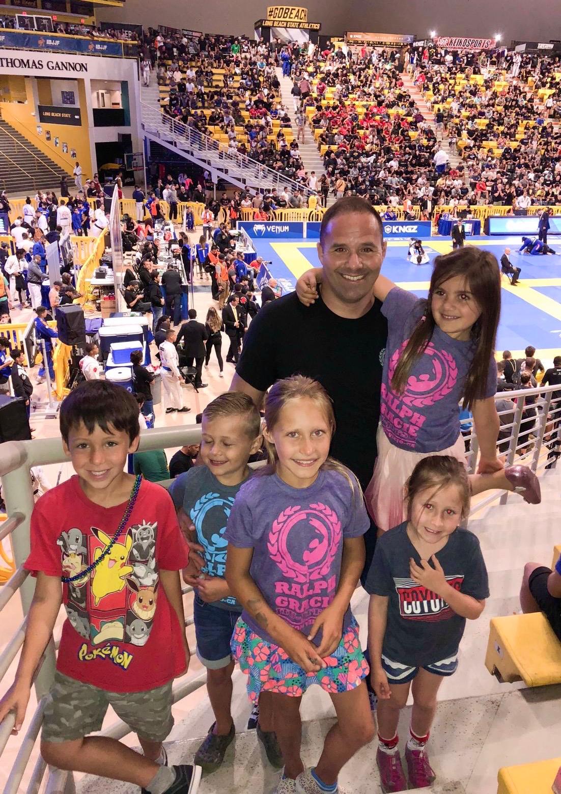 Professor Bob with students at a BJJ tournament arena