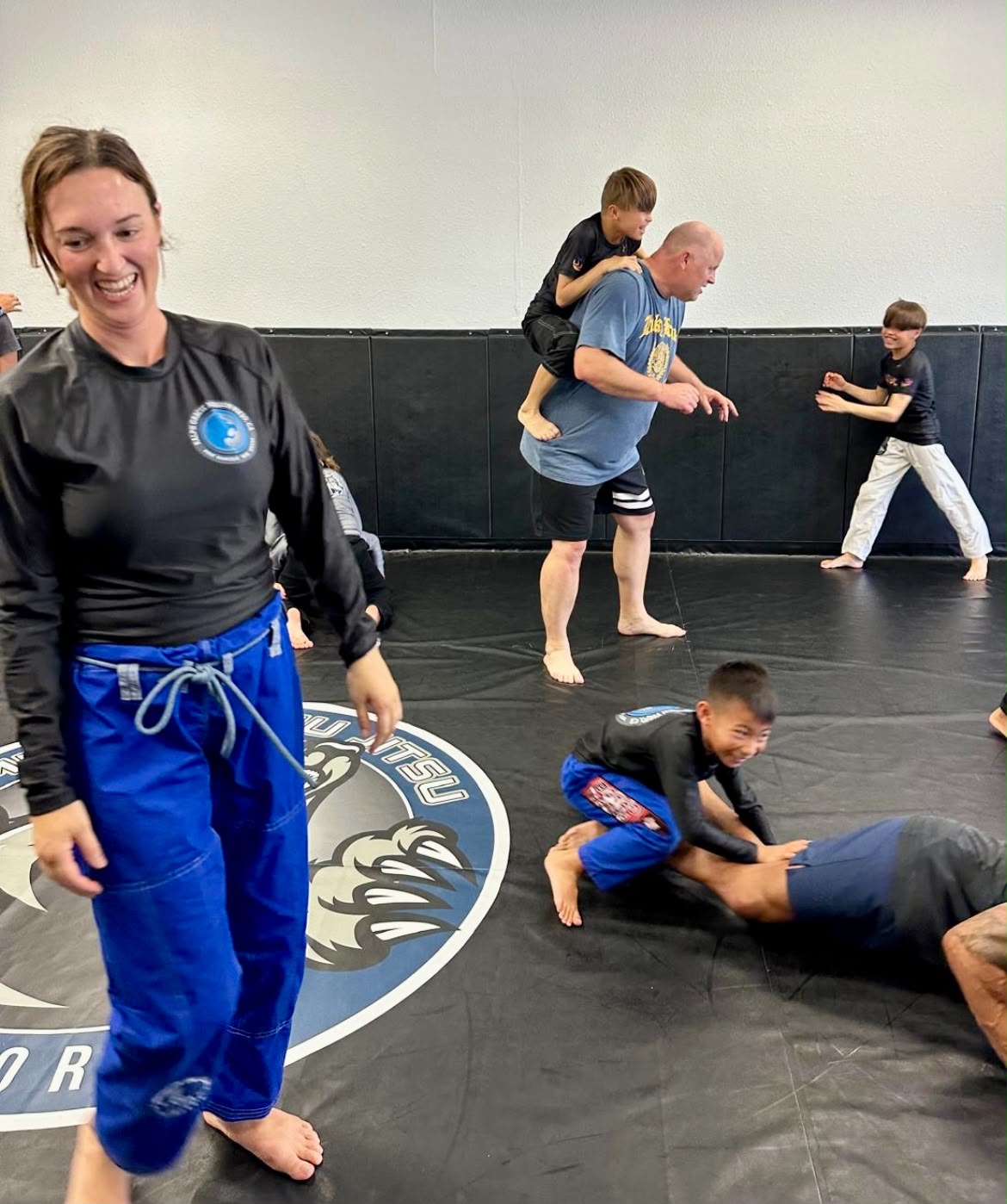 Parents and kids laughing together during class at Ralph Gracie Jiu-Jitsu Mission Viejo