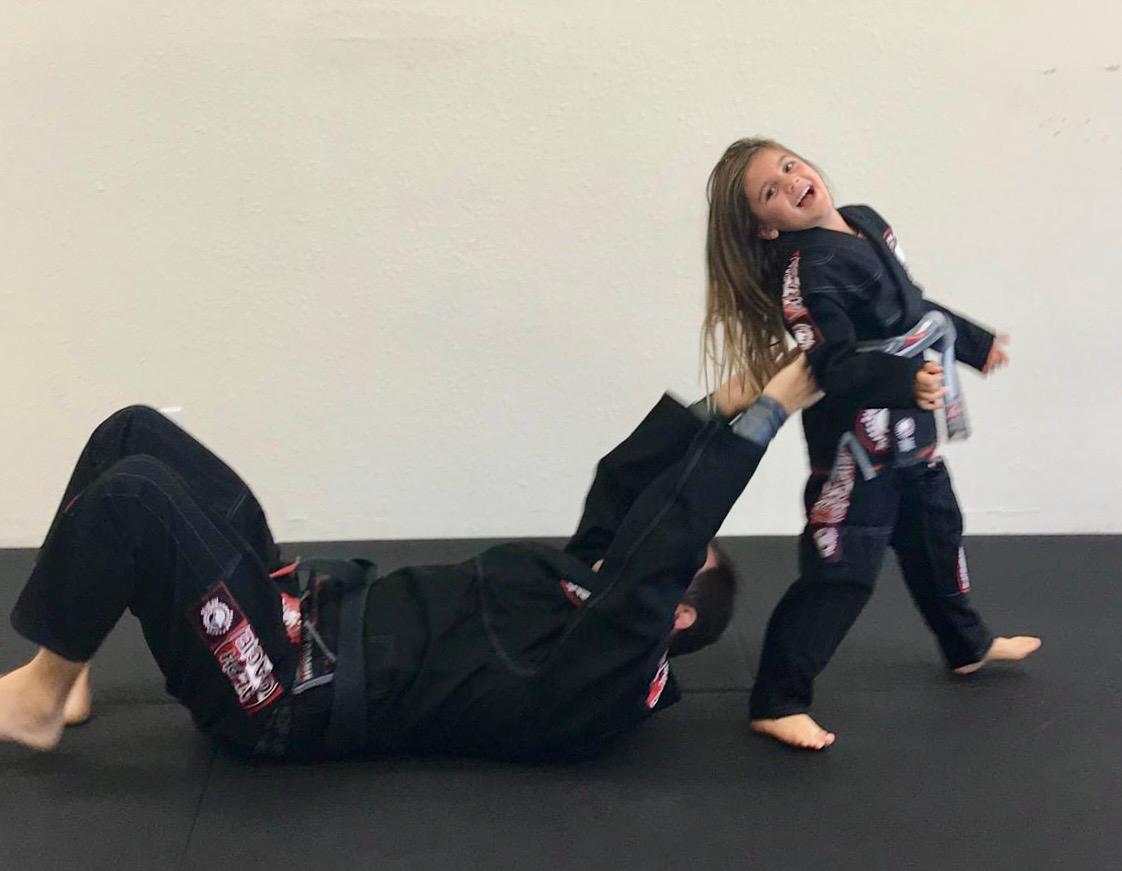 Professor Bob playing jiu-jitsu with a young student