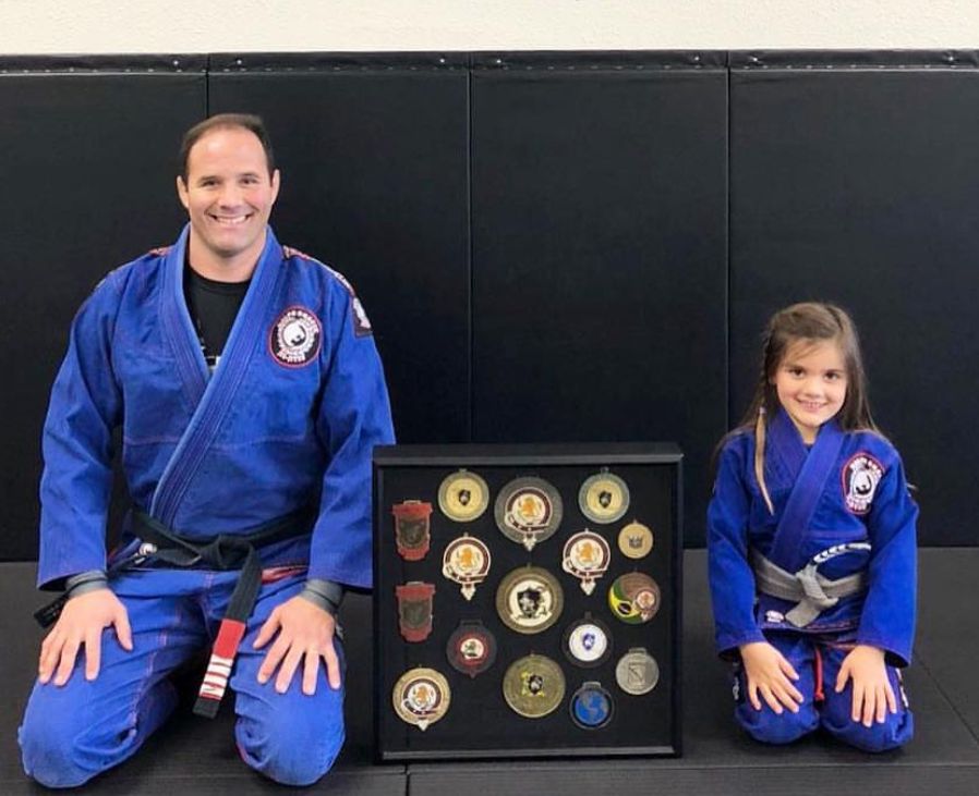 Professor Bob with student and medal display