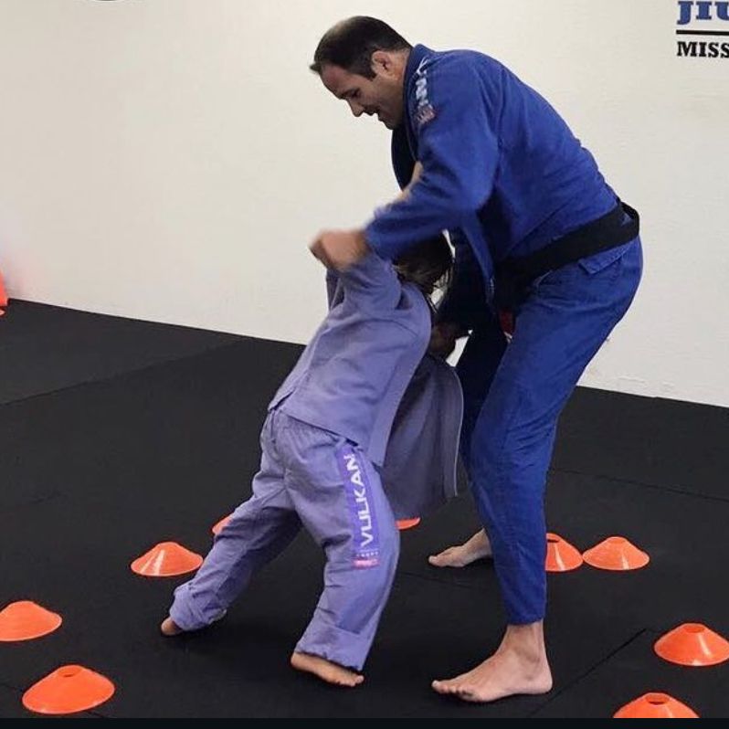Professor Bob teaching kids takedown drill