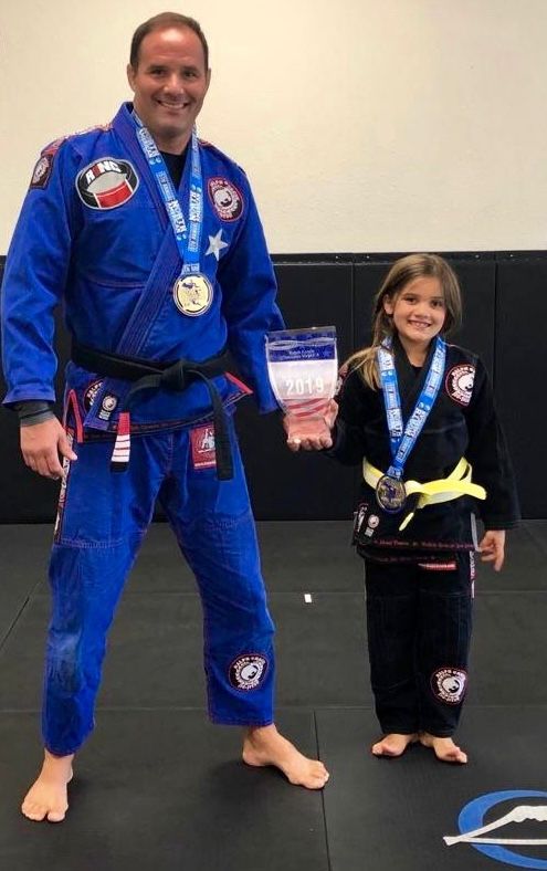 Professor Bob with young student and championship trophy
